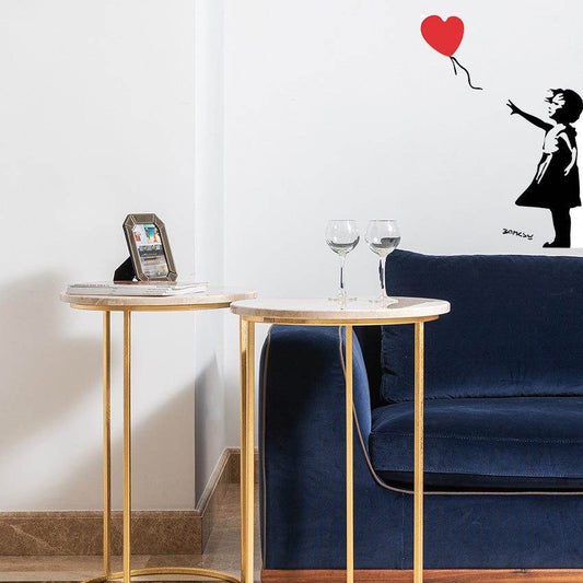 A living room with a Banksy Balloon Heart Wall Sticker of a girl flying a balloon.