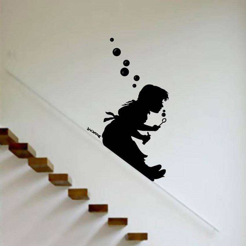 A Banksy Bubble Girl wall decal featuring the silhouette of a girl playing with bubbles.