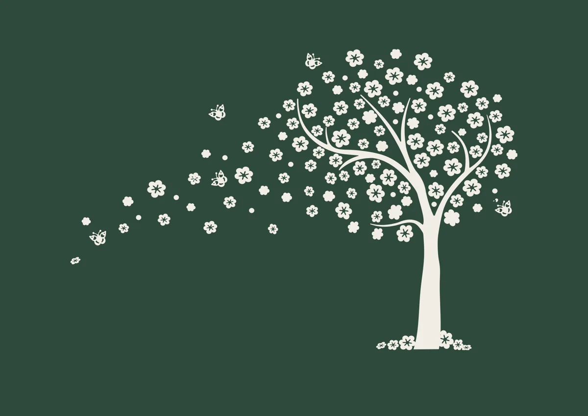 Tree with blossom petals blowing from its branches