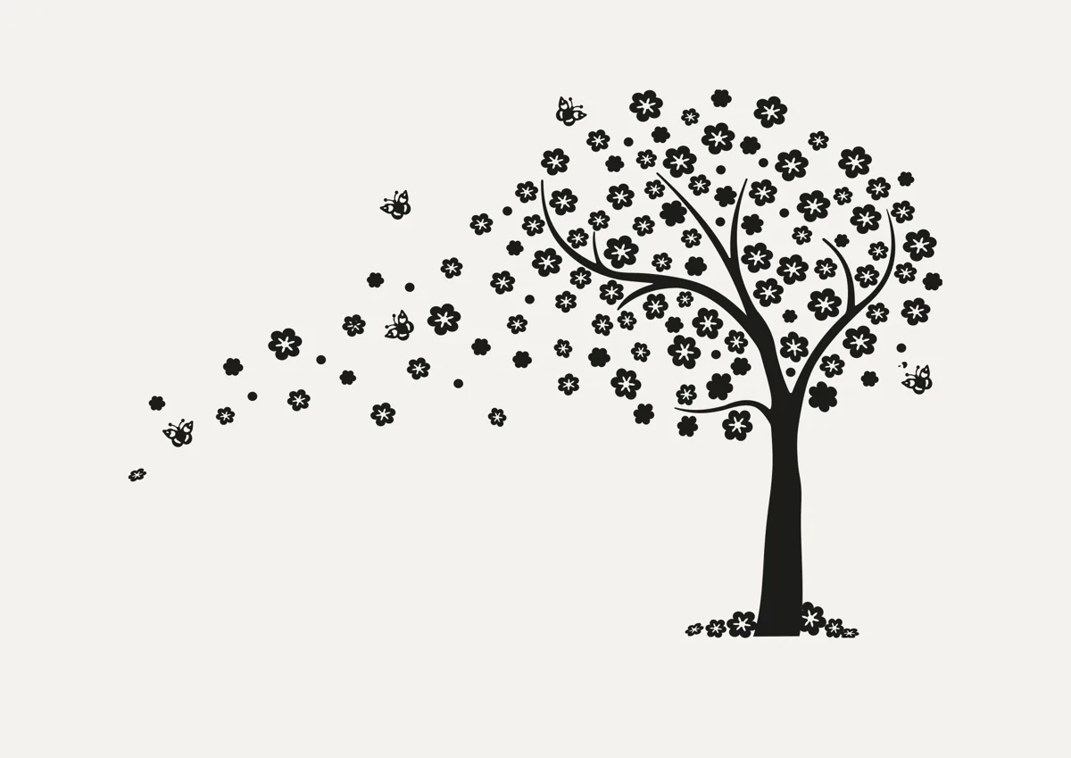 Tree with blossom petals blowing from its branches