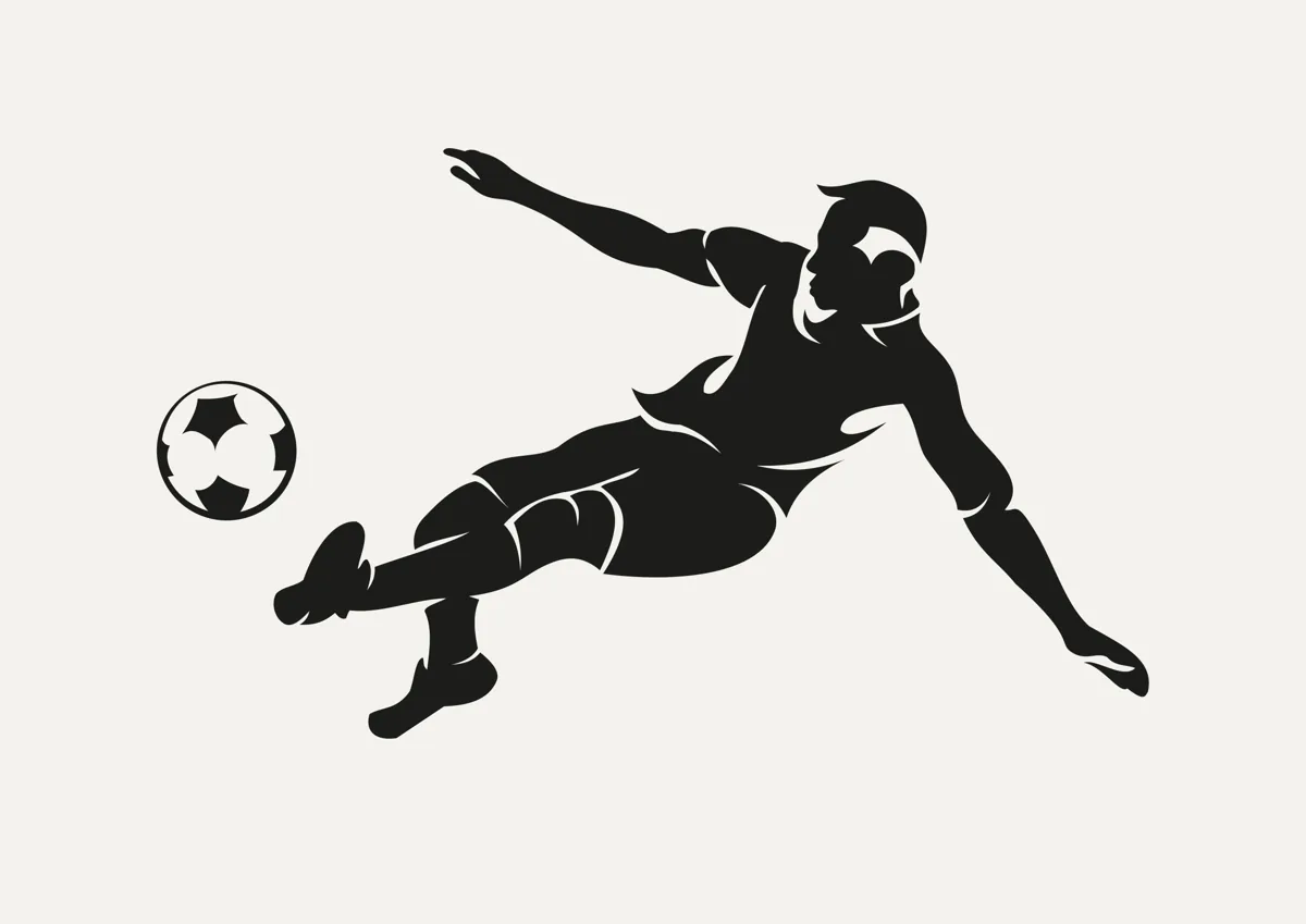 Footballer leaping to volley the ball, silhouette