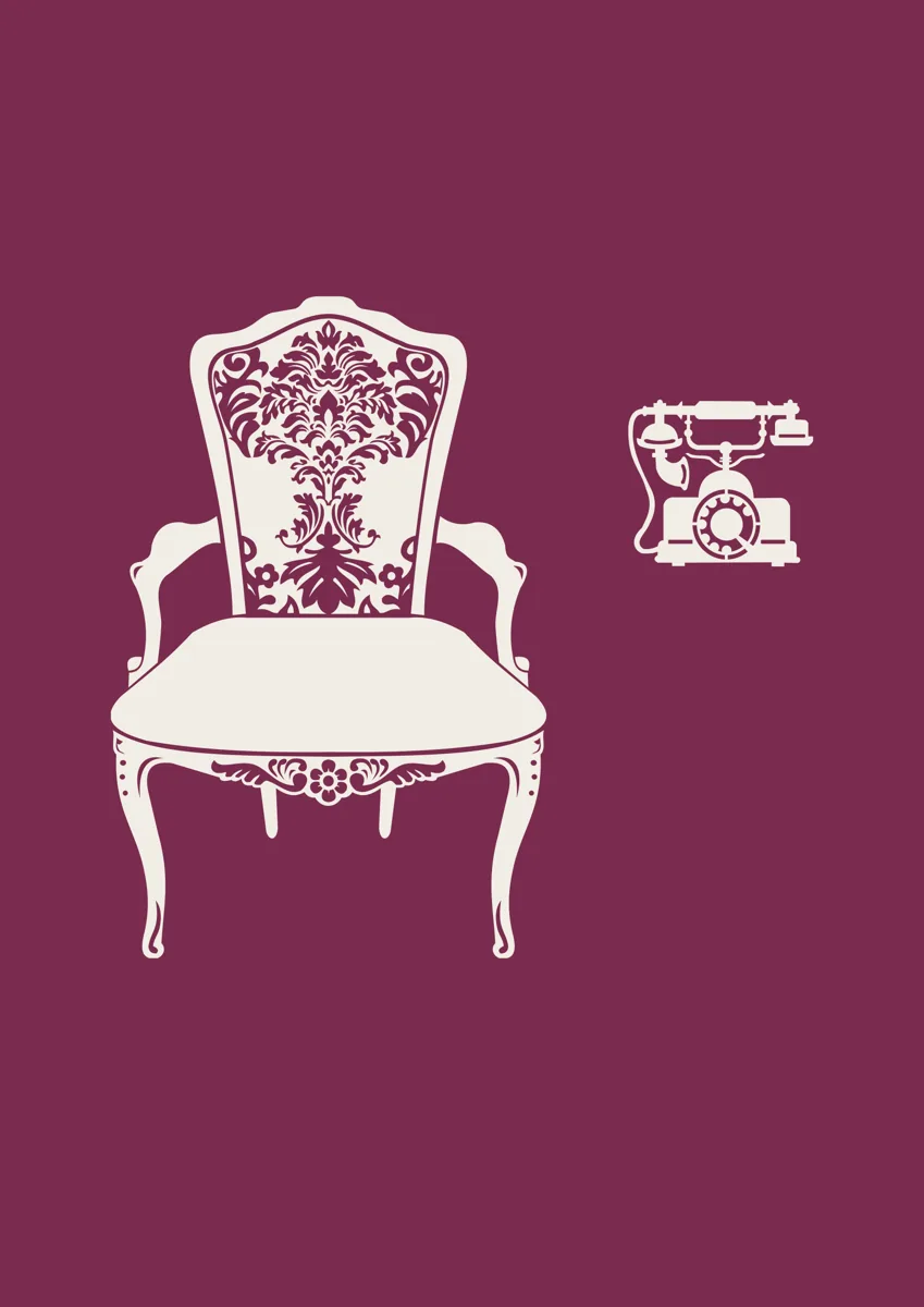Ornate armchair beside a vintage rotary telephone
